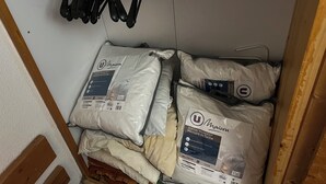 A storage area with several bags of U Maison memory foam pillows and a set of black kitchen utensils hanging on the wall. - Les Arcs 1800: studio - 1 room - 4/5 persons (Bourg-Saint-Maurice)