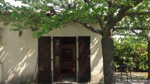 A rustic building with a wooden door and a small porch area. - House / Villa - SampzonHouse with garden (Sampzon)