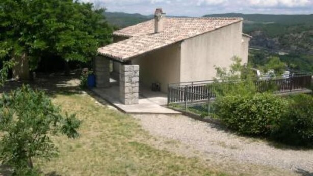 A small, single-story building with a tiled roof, surrounded by greenery and hills. - House / Villa - SampzonHouse with garden (Sampzon)