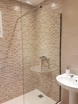 Shower, hair dryer, towels, toilet paper