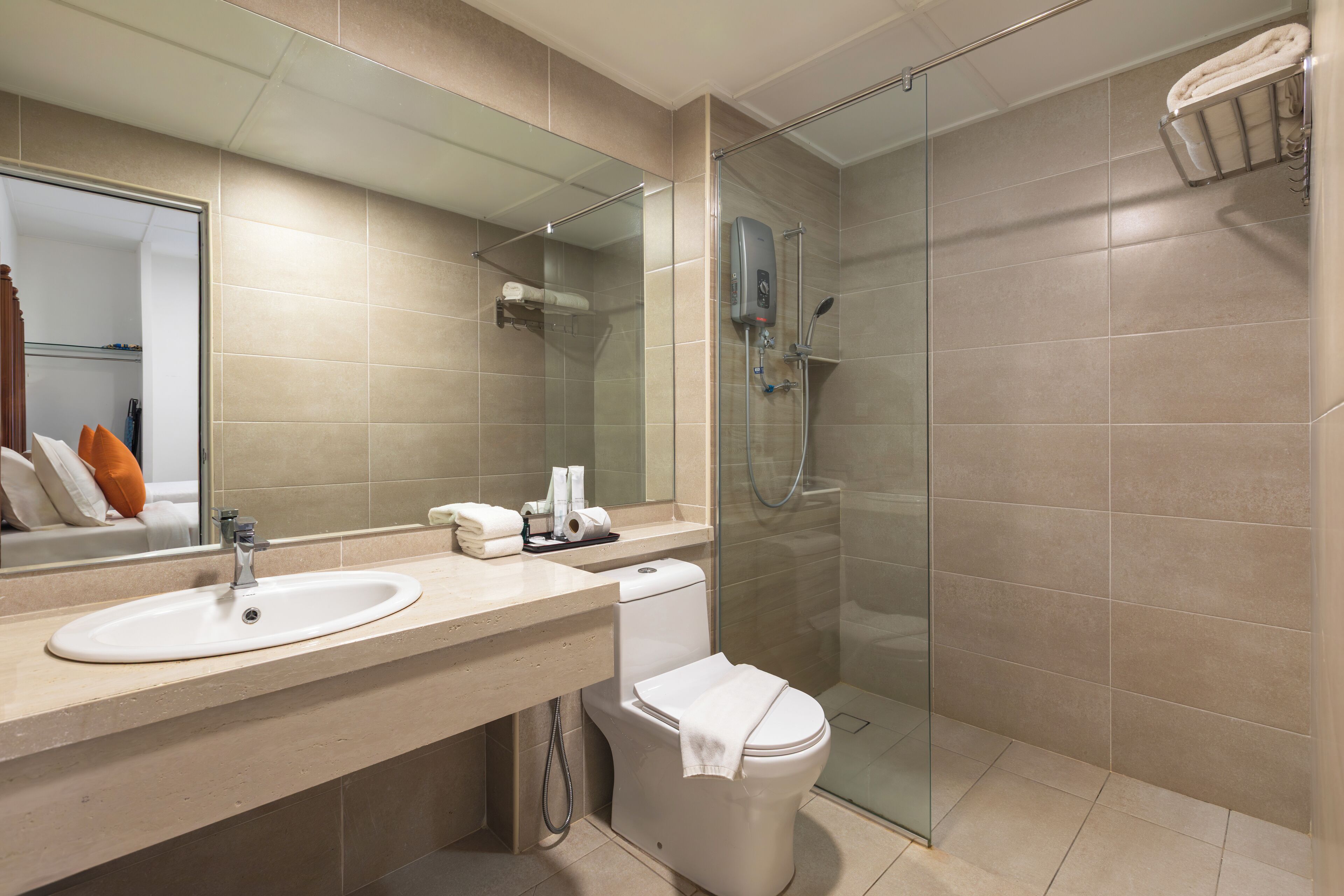 A modern bathroom with a glass-enclosed shower, a sink, and a toilet.