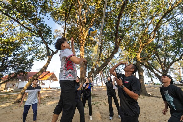 A group of people playing volleyball outdoors. - Adena Beach Resort (Kuantan)