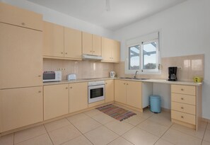 Enjoy cooking in this well-equipped kitchen with oven, microwave, and coffee maker.