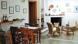 A dining area with wooden furniture, a fireplace, and wall-mounted shelves with decorative items. - Villa Gilda, with last minute swimming pool t 03 - 21 September !!! (Pula)