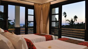 A hotel room with two beds, large windows, and a view of the ocean. - Exclusive 5 star villa with 365 ° view of the sea, mountains and rice fields! (Kayu Putih)