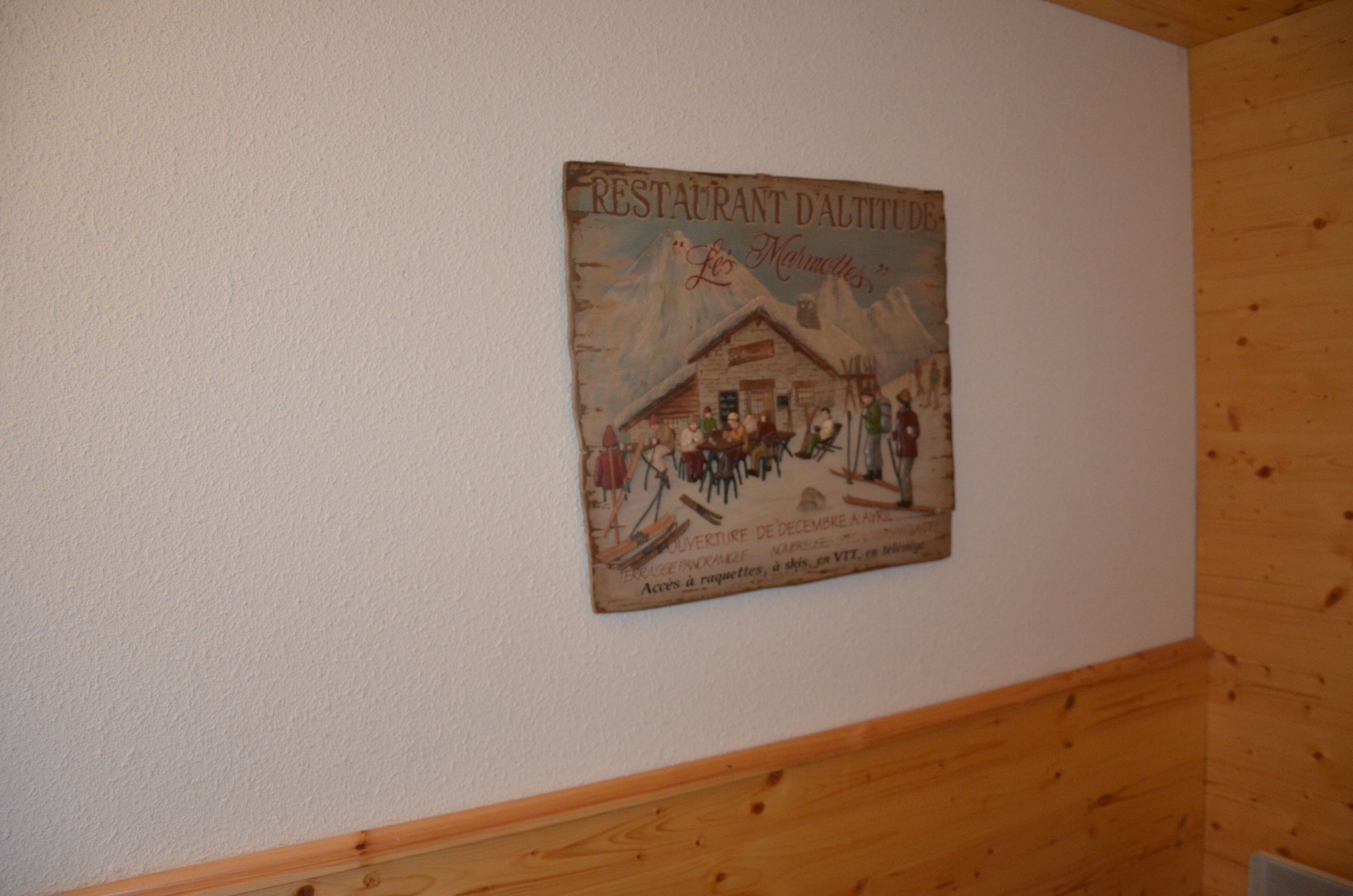 A wall with a vintage poster of a restaurant.