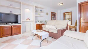 A living room with a television, sofa, and coffee table. - ROSER (ROSER DE ARTÀ) - Townhouse with terrace in Artà. Free WiFi (Artà)