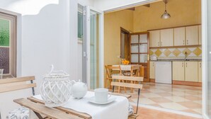 A dining area with a table set for two, a white teapot, and a cup. - ROSER (ROSER DE ARTÀ) - Townhouse with terrace in Artà. Free WiFi (Artà)