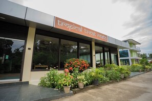A modern building with a sign reading "tropical treat restaurant". - Hotel Neha Palace (Port Blair)