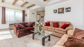 A modern living room with a glass coffee table, two sofas, and a fireplace. - Villa LURDA with a magnificent sea view and heated pool (Linardići)