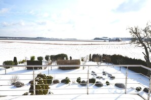Panoramic views of a serene snow-covered landscape unfold from this peaceful retreat.