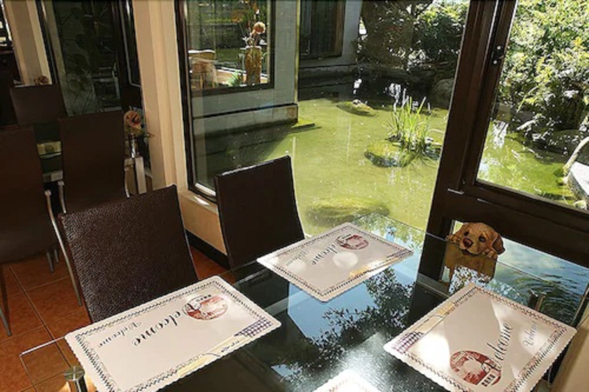 A dining area with two tables, each with a placemat featuring a logo.