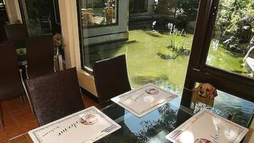 A dining area with two tables, each with a placemat featuring a logo.