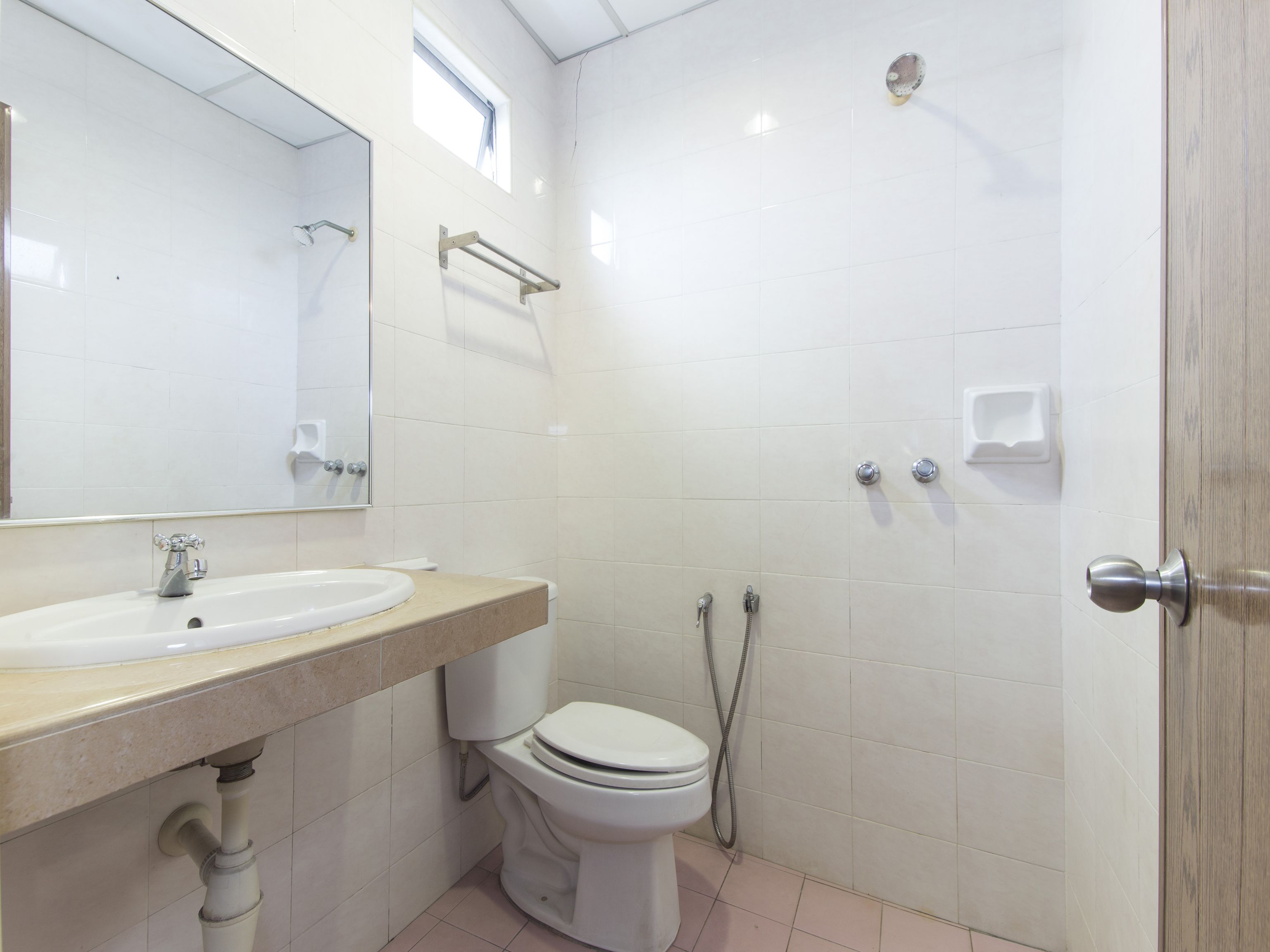 A bathroom with a sink, toilet, and shower.