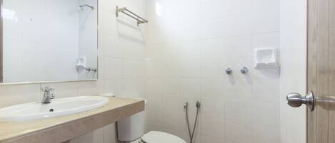 A bathroom with a sink, toilet, and shower.