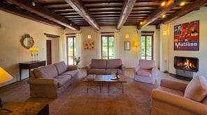 A living room with a fireplace, sofas, and a coffee table.