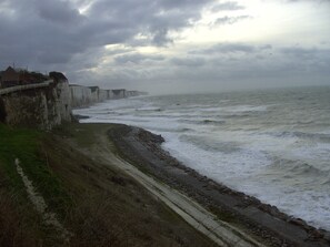 A coastal road with cliffs and a sea view.