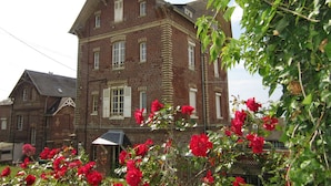 A historic brick building with multiple windows and a prominent entrance. - Apartment in villa for 6 persons-2**- . Sea view, somme bay.    (Ault)