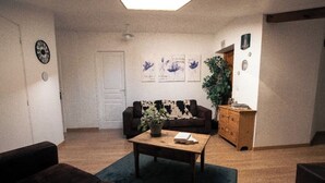 A living room with a sofa, a coffee table, and a potted plant. - Quiet country house with swimming pool, ideal location. (Tauriers)