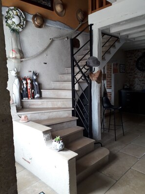 Staircase leading to an upper level with a modern design and decorative elements.