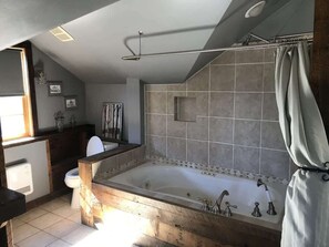 Bathtub, hair dryer, towels, shampoo