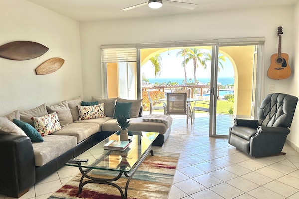 Living room with idyllic ocean view and steps away from the pool.
