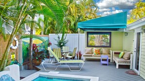 A pool area with a hot tub, lounge chairs, and a covered seating area with a view of the pool. - Key West Wabi Sabi - Authentic Downtown Cottage w Pool - Steps Off Duval (Key West)