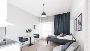 A modern, well-lit apartment with a kitchen, dining area, and a cozy living space. - Forenom Serviced Apartments Helsinki Mansku (Helsinki)
