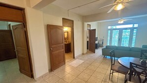 A spacious living area with a dining table, chairs, a sofa, and a ceiling fan. - Modern Oasis On Tropical (Vieques)