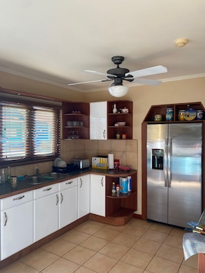 Enjoy cooking in this well-equipped kitchen with an oven and stainless steel refrigerator.