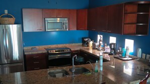 A kitchen with granite countertops, stainless steel appliances, and wooden cabinets. -  Stunning ocean and one of Mazatlans top tourist attractions cliff divers view. (Mazatlán)