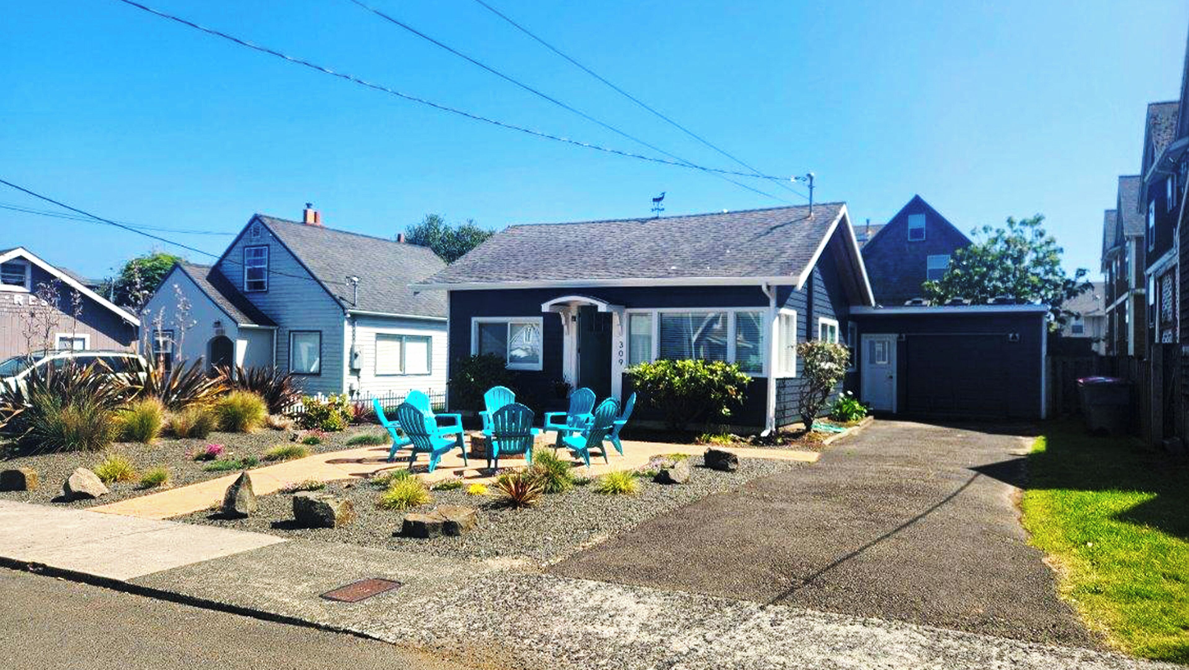 A residential house with a front yard, a driveway, and a garage.