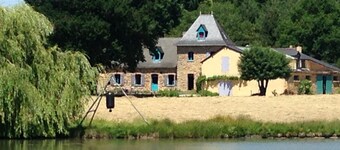 Farmhouse in the woods, on a lake shore