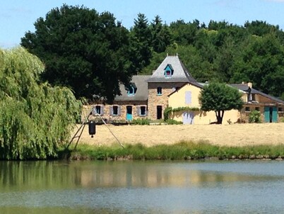 Farmhouse in the woods, on a lake shore