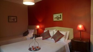 A hotel room with two beds, a bedside table with a lamp, and a tray with tea cups. - 3 Double Bedroom, Right Next to Blue Mosque, on Akbiyik Street (Istanbul)