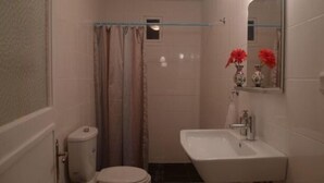 A bathroom with a toilet, a sink, and a shower area. - 3 Double Bedroom, Right Next to Blue Mosque, on Akbiyik Street (Istanbul)