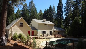 A two-story house with a patio and a swimming pool, surrounded by tall trees. - A Foresthill Retreat (Foresthill)