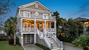 A two-story house with a covered front porch, a staircase, and a garage.