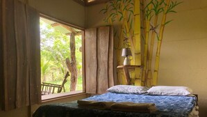 A room with a bed, a window with curtains, a lamp on a shelf, and a bamboo wall mural. - Panorama: Vista Paradise – Integrated Rural Turism Farm (Monteverde)