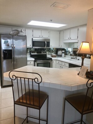 Enjoy cooking in this well-equipped kitchen with an oven, refrigerator, and stove.