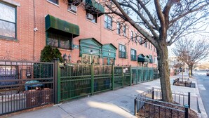 A brick building with a green gate and a tree in front. - 2 Bedrooms Fully Furnished Rental Apartment Entire @ Marion Extended Stay, USA (Brooklyn)