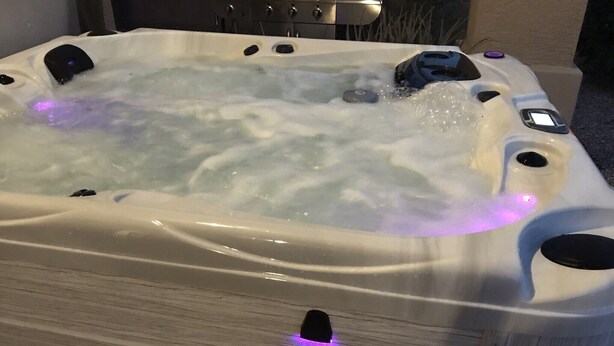 A hot tub with visible bubbles and a control panel. - BEAUTIFUL MTN VIEW , HOT TUB & NEAR GOLF (Laveen)