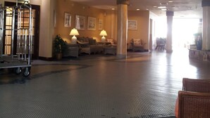 A spacious lobby with a high ceiling, ceiling fans, and a seating area with lamps. - Gorgeous Ocean View & Heated Pool! Seasonal Discounts (Daytona Beach)
