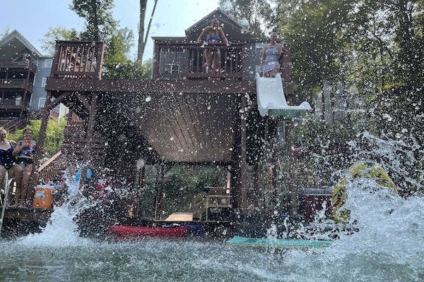 A premier waterfront oasis with a jumping platform, wet chair, and waterslide.
