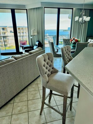 Enjoy a coastal view from the large window, relax in the comfortable seating area, and dine at the table with a chandelier above.