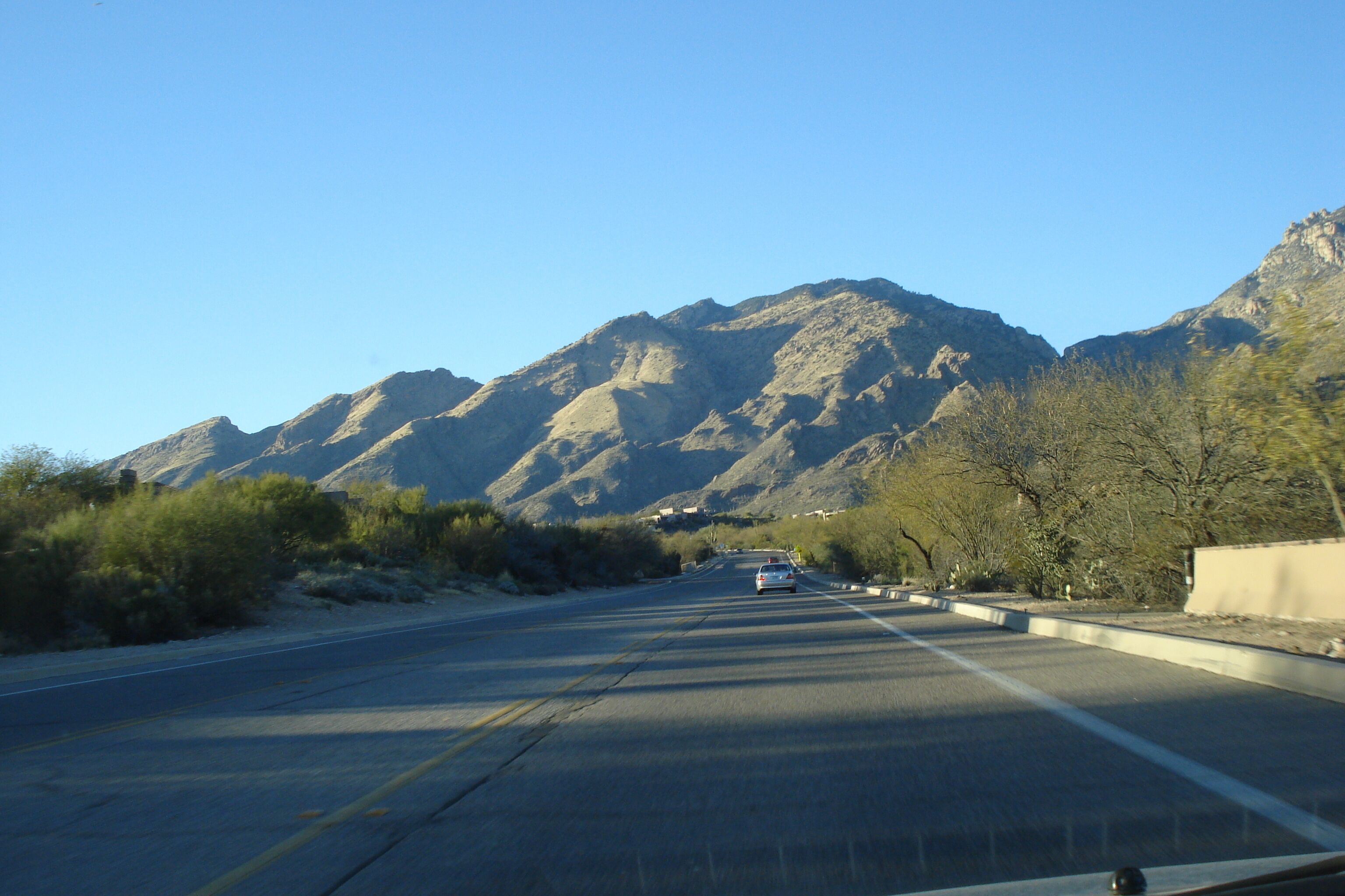 A road with mountains in the background.
