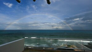 A balcony with a view of the ocean and a rainbow. - Breathtaking 7 Bedroom Villa on the Ocean with a Infinity Private Pool (Isla Mujeres)