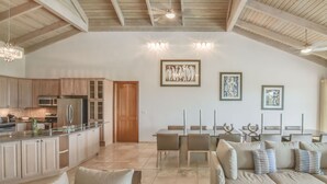 A spacious living area with a kitchen, dining table, and seating.