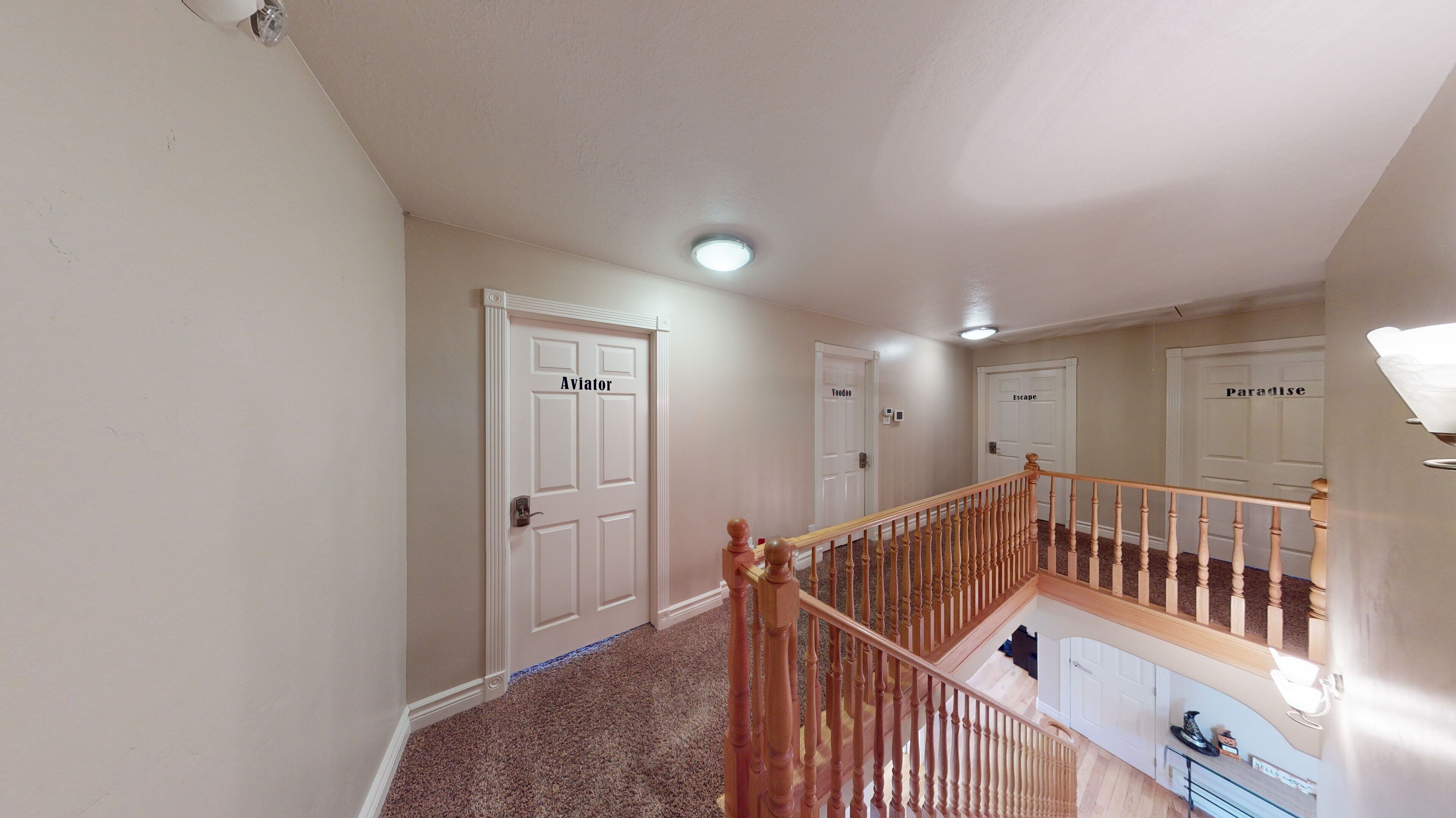 A hallway with three doors labeled "Avion," "VooDoo," and "Escape."