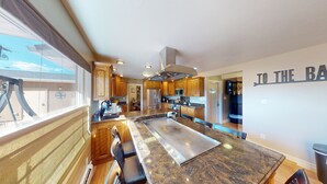A modern kitchen with wooden cabinets, granite countertops, and stainless steel appliances. - Tacit Shadow - Single/Queen Sleeps 3 (Parowan)